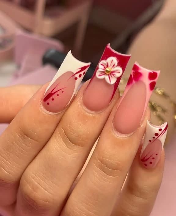 Full acrylic set with crimson French tips and hand-painted floral nail art